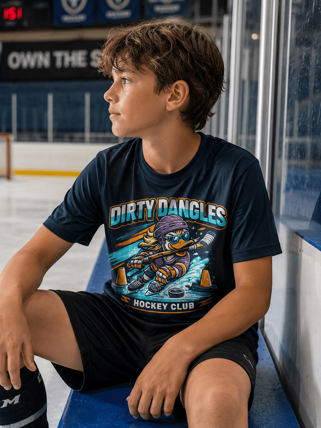 Kid wearing a Dirty Dangles Hockey Club tee